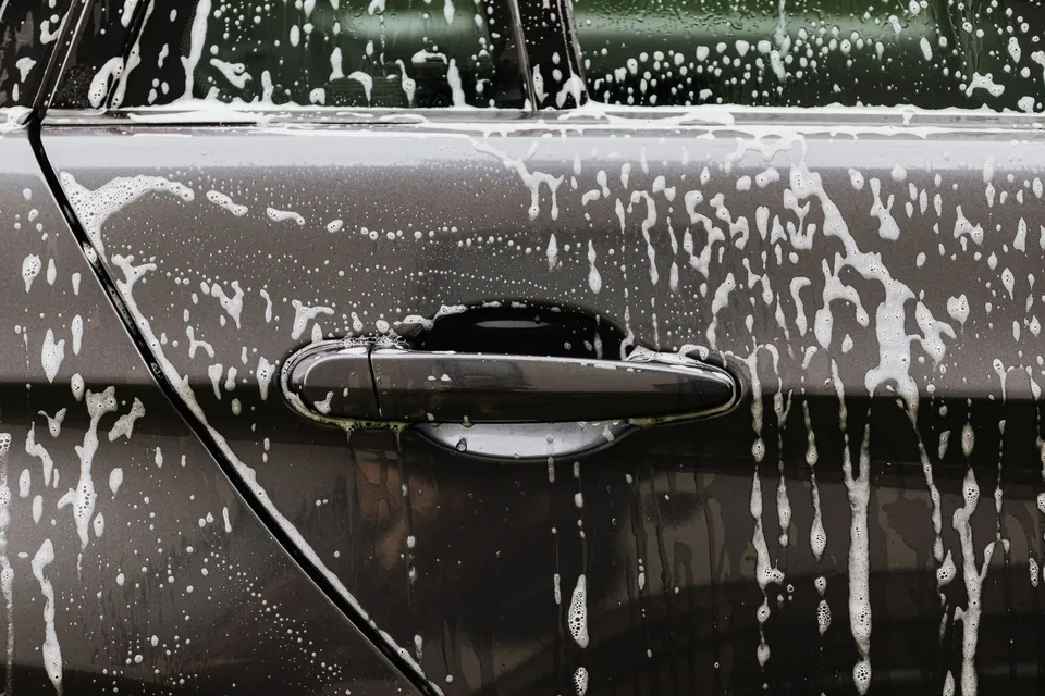 Soap foam on a dark car door
